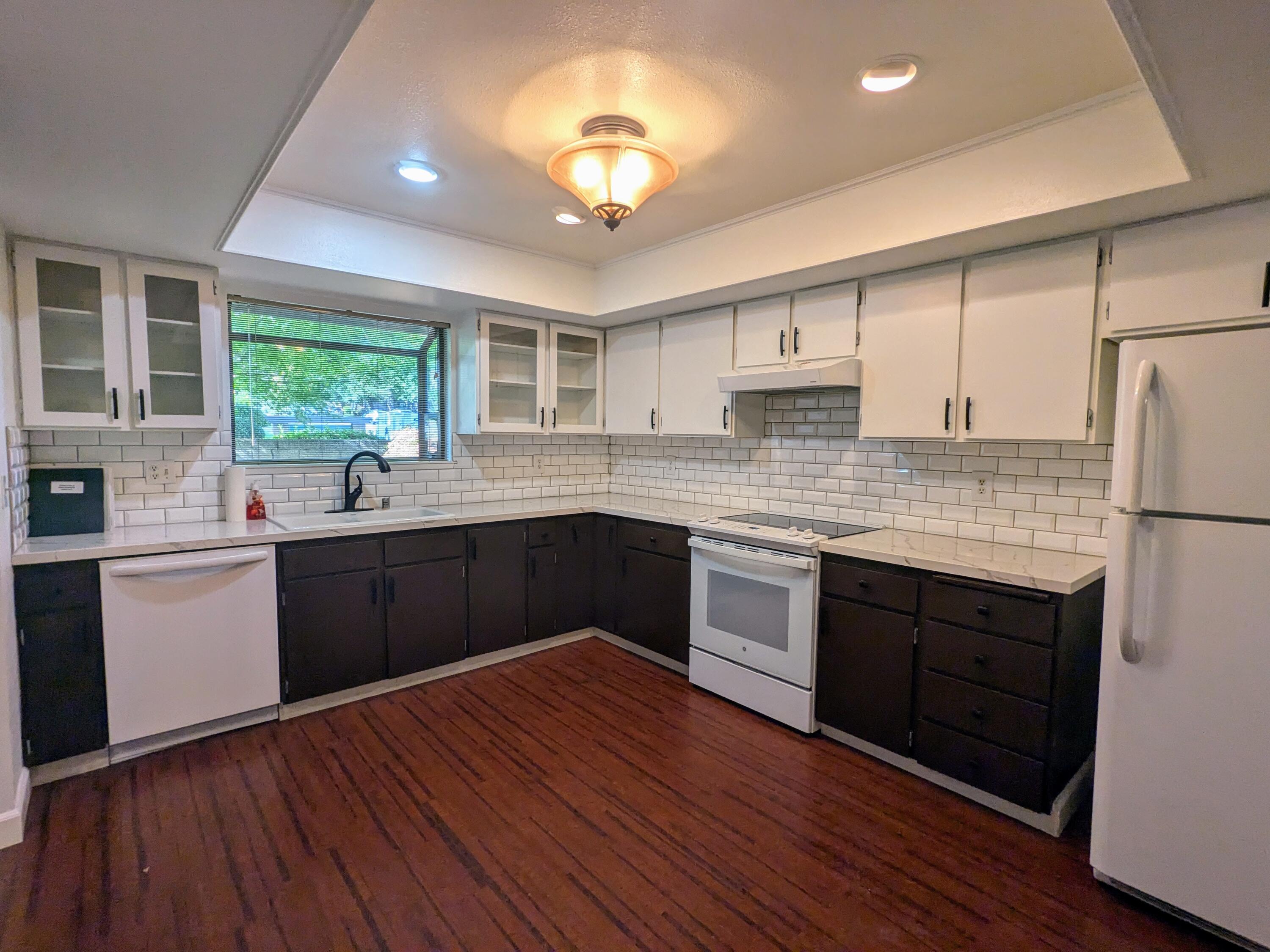 1974 Bechelli Lane Redding, CA 96002 - Photo 18 of 49 a kitchen with a sink cabinets wooden floor and stainless steel appliances