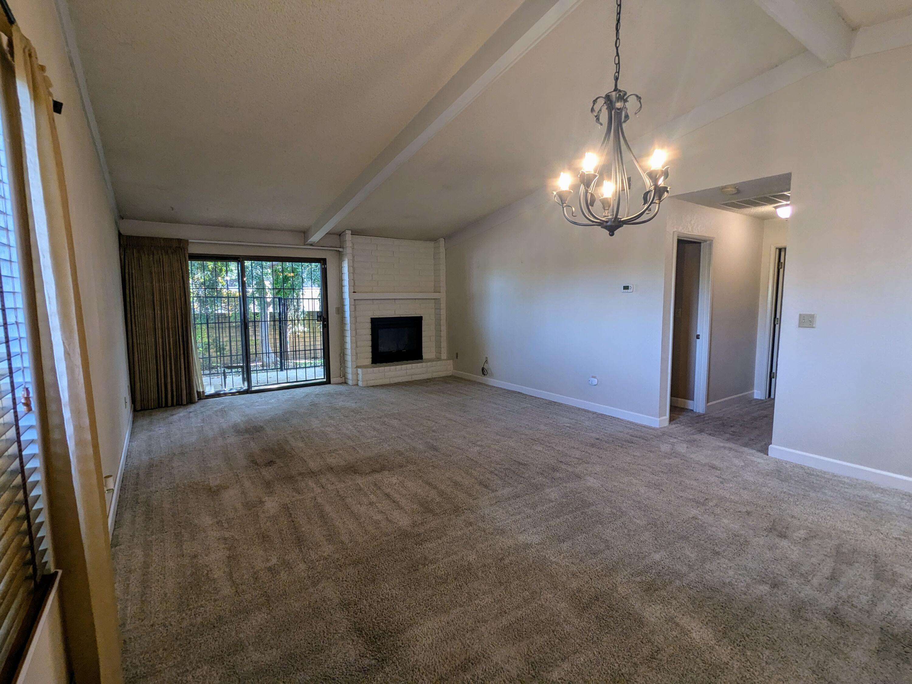 1974 Bechelli Lane Redding, CA 96002 - Photo 25 of 49 a view of an empty room with chandelier and a fireplace