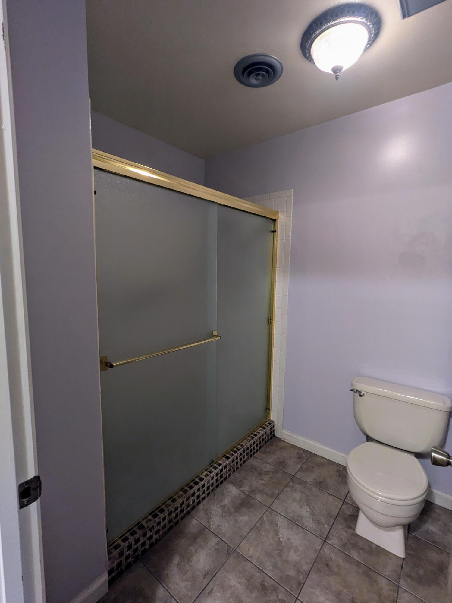 1974 Bechelli Lane Redding, CA 96002 - Photo 42 of 49 a bathroom with a toilet and a shower