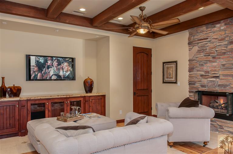 70551 Sunny Lane Rancho Mirage, CA 92270 - Photo 15 of 35 a living room with furniture a chandelier and a flat screen tv