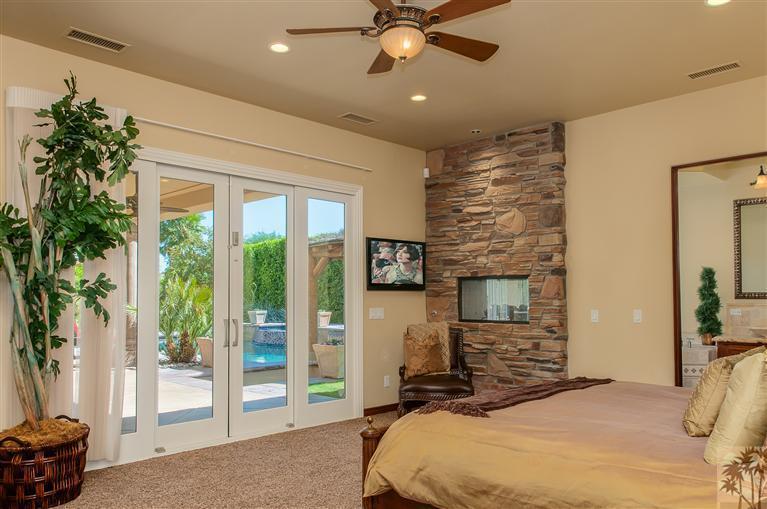 70551 Sunny Lane Rancho Mirage, CA 92270 - Photo 17 of 35 a bedroom with a bed and a tv