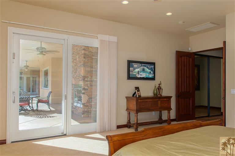70551 Sunny Lane Rancho Mirage, CA 92270 - Photo 21 of 35 a bedroom with a bed and a mirror