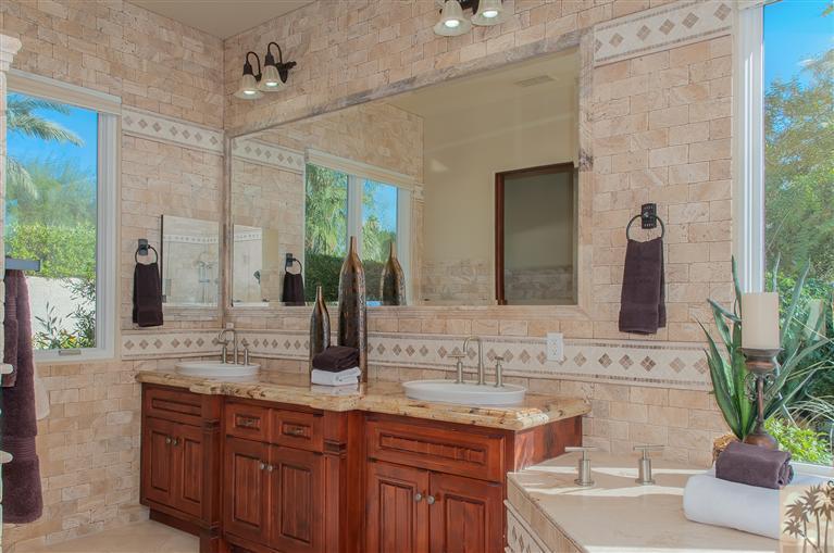 70551 Sunny Lane Rancho Mirage, CA 92270 - Photo 22 of 35 a bathroom with a granite countertop sink and a mirror