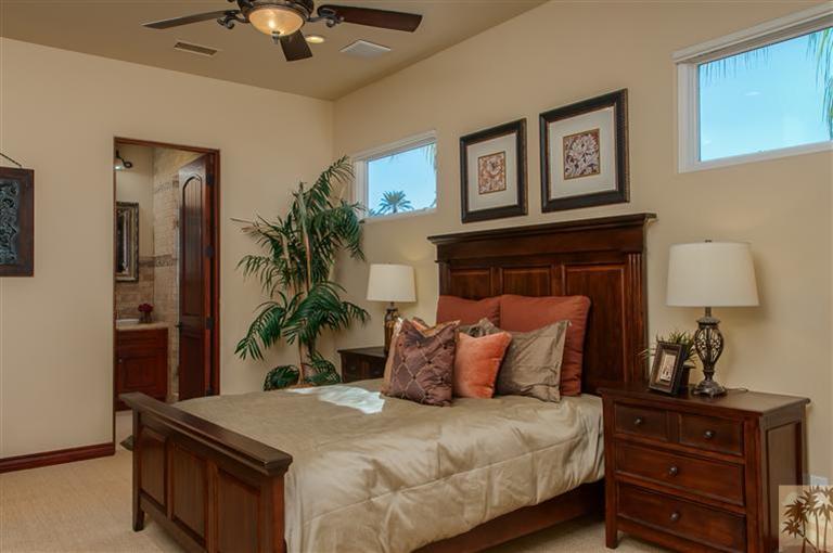 70551 Sunny Lane Rancho Mirage, CA 92270 - Photo 24 of 35 a bedroom with a bed and a potted plant on the dresser