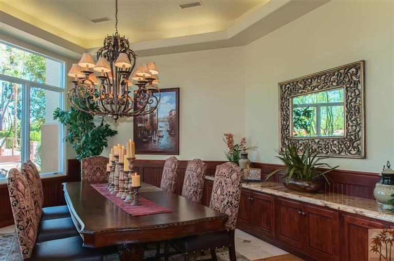 70551 Sunny Lane Rancho Mirage, CA 92270 - Photo 6 of 35 a view of a dining room with furniture a chandelier and large windows