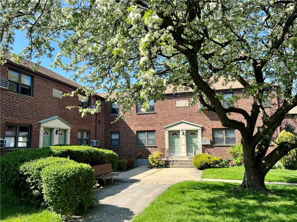 a front view of a house with yard and green space