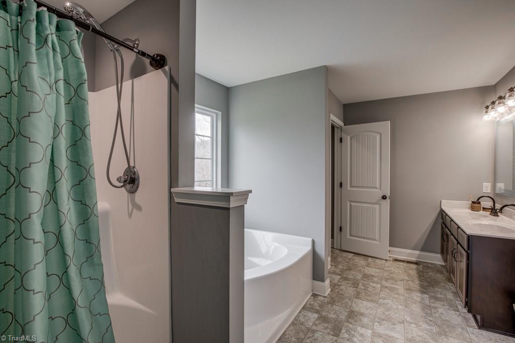 7408 Princess Ann Court Rural Hall, NC 27045 - Photo 17 of 30 Master bathroom with toilet closet, separate shower and garden tub.