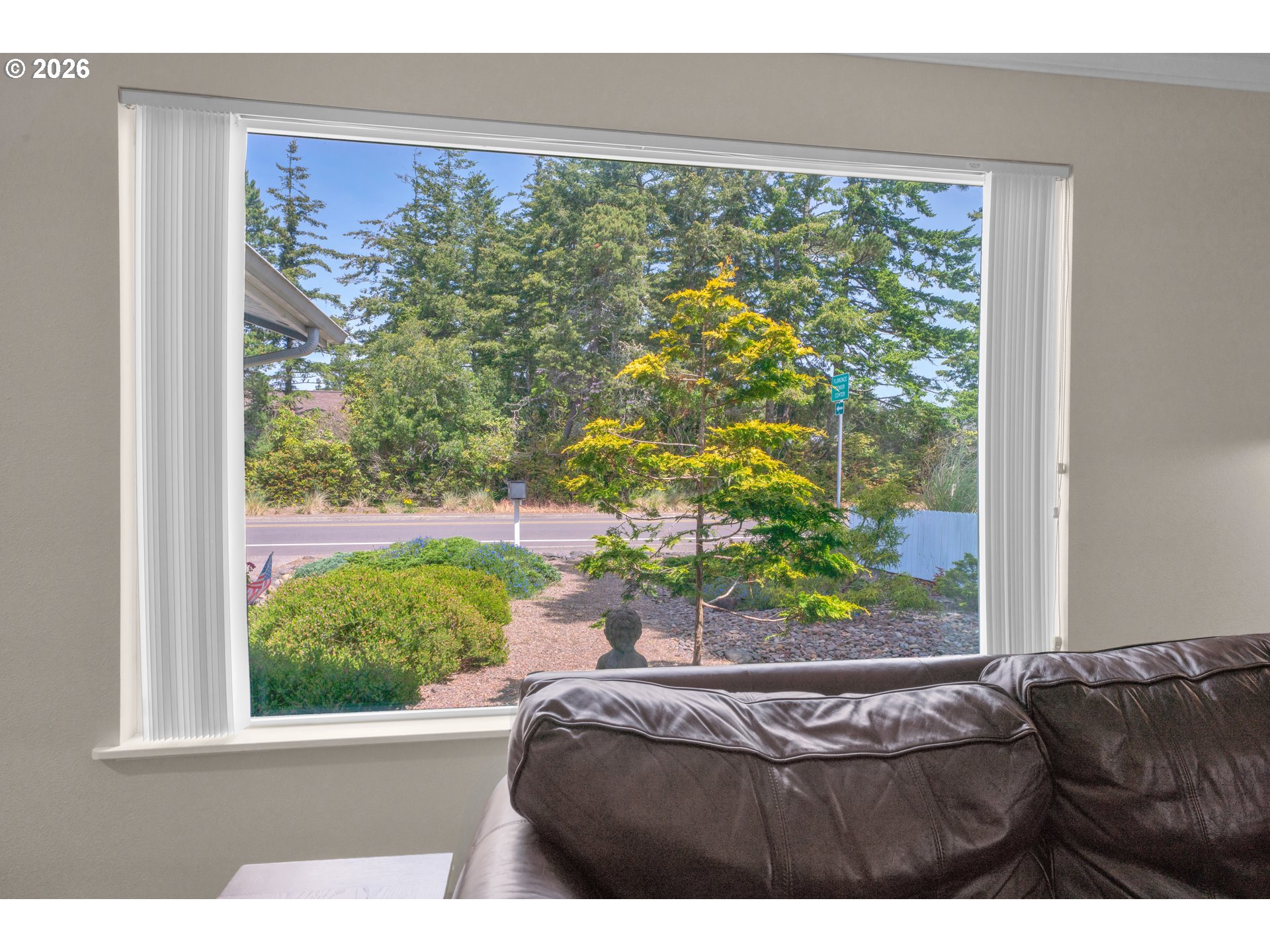 1142 9th Street Florence, OR 97439 - Photo 9 of 41 a bed sitting in a window next to a window