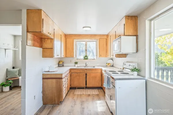 a kitchen with a stove a sink and a refrigerator