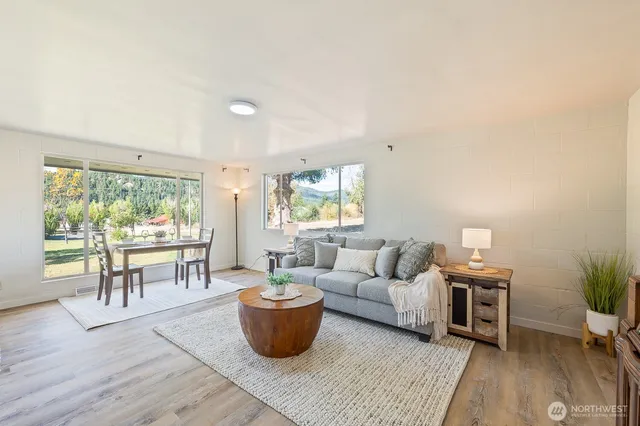 a living room with furniture and a wooden floor