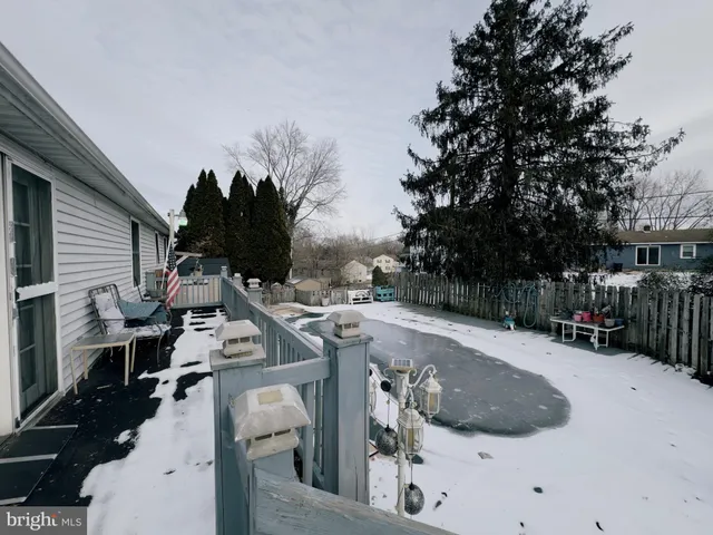 a view of roof deck with table and chairs a barbeque with wooden fence