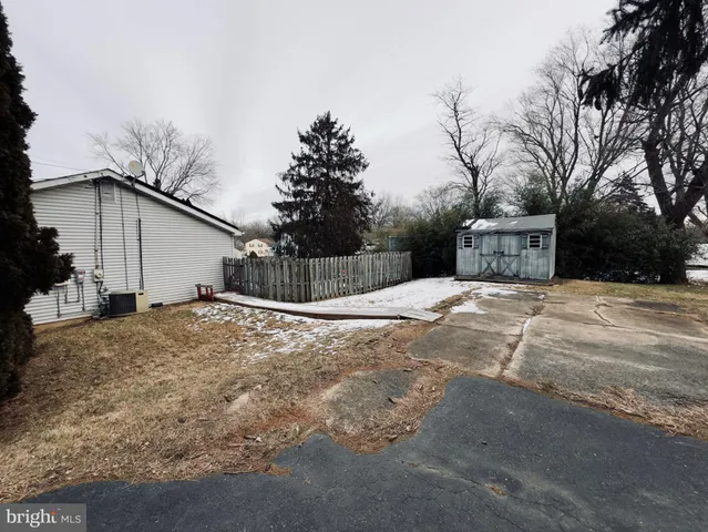 a view of a house with snow on the road