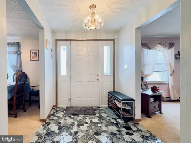 a bedroom with furniture and a chandelier
