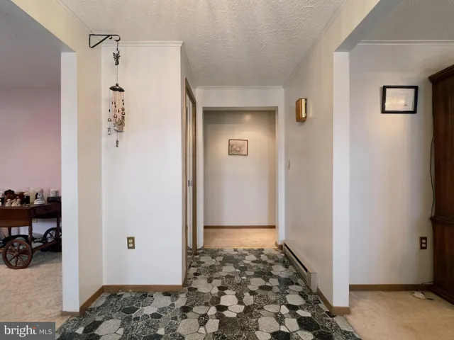 a view of a hallway with closet and wooden floor
