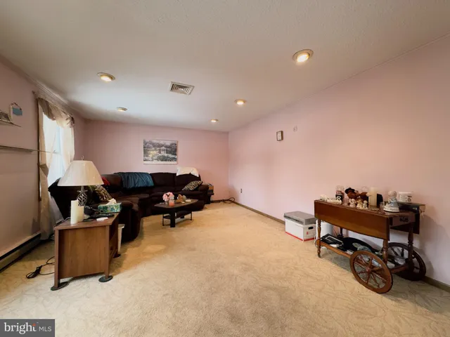 a living room with furniture and a chair