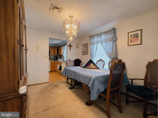 a view of a livingroom with furniture and a chandelier