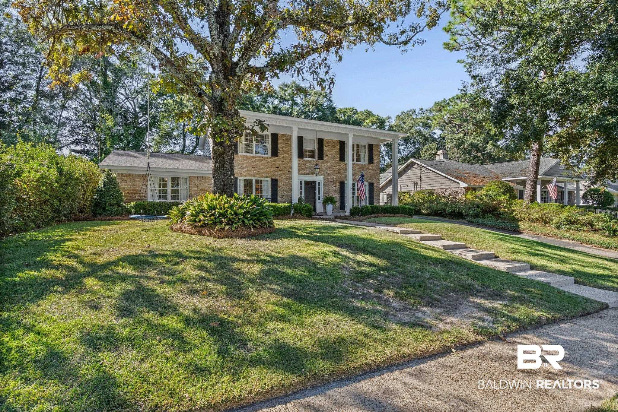 513 Spring Park Drive East Mobile, AL 36608 - Photo 40 of 44 Greek revival inspired property featuring a porch, a front lawn, and brick siding