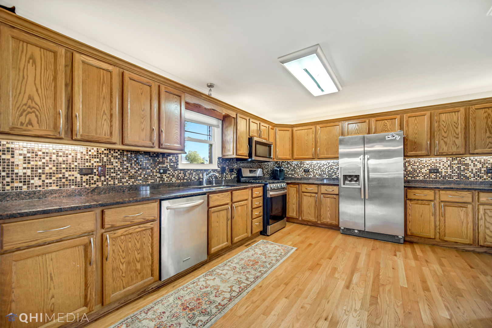 7930 Farmhouse Road Frankfort, IL 60423 - Photo 7 of 24 a kitchen with granite countertop stainless steel appliances a sink cabinets and a counter top space