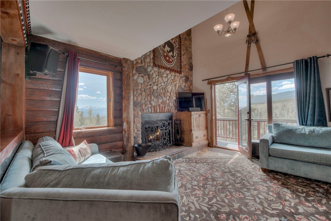 9460 Ryan Gulch Road, Unit 60 Silverthorne, CO 80498 - Photo 5 of 34 Living area with walkout to deck and National Forest