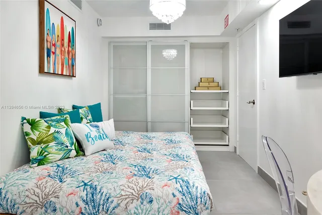 a bedroom with a bed and a flat screen tv