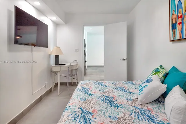 a bedroom with a bed and flat screen tv