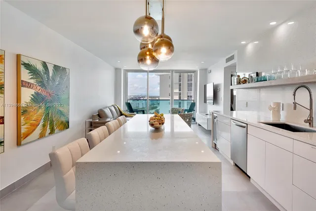 a kitchen with a sink a counter space and dining table