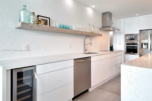 a kitchen with kitchen island a sink stainless steel appliances and cabinets