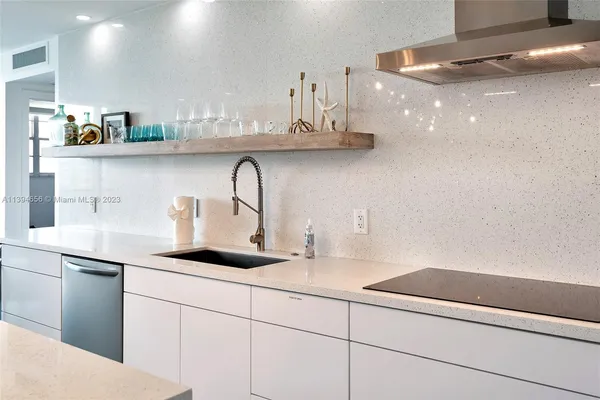 a kitchen with stainless steel appliances a sink and cabinets