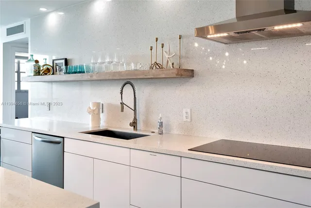 a kitchen with stainless steel appliances a sink and cabinets