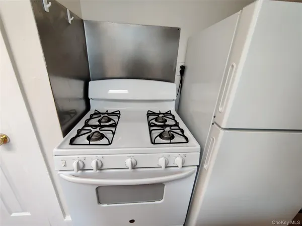 a kitchen with a refrigerator and a stove top oven