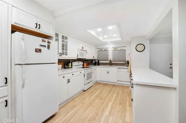 a kitchen with cabinets and window