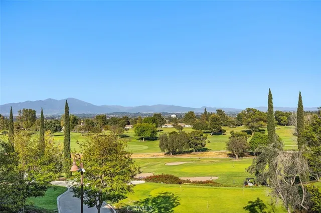 a view of a patio with a table and chairs under an umbrella