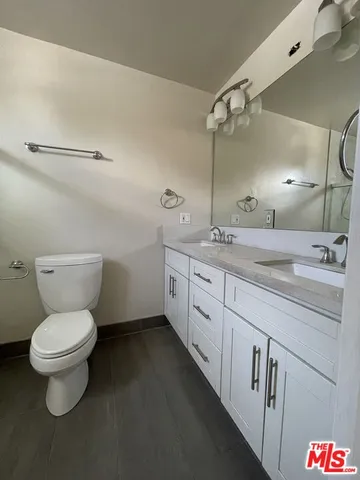 a bathroom with a toilet sink and a mirror