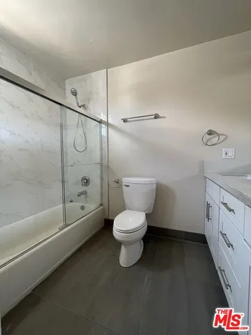 a bathroom with a toilet sink and shower