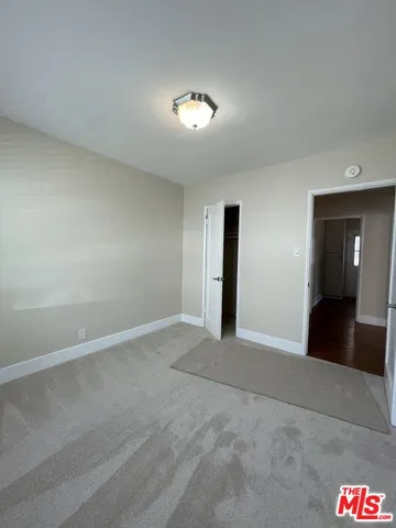 a view of an empty room and a lamp