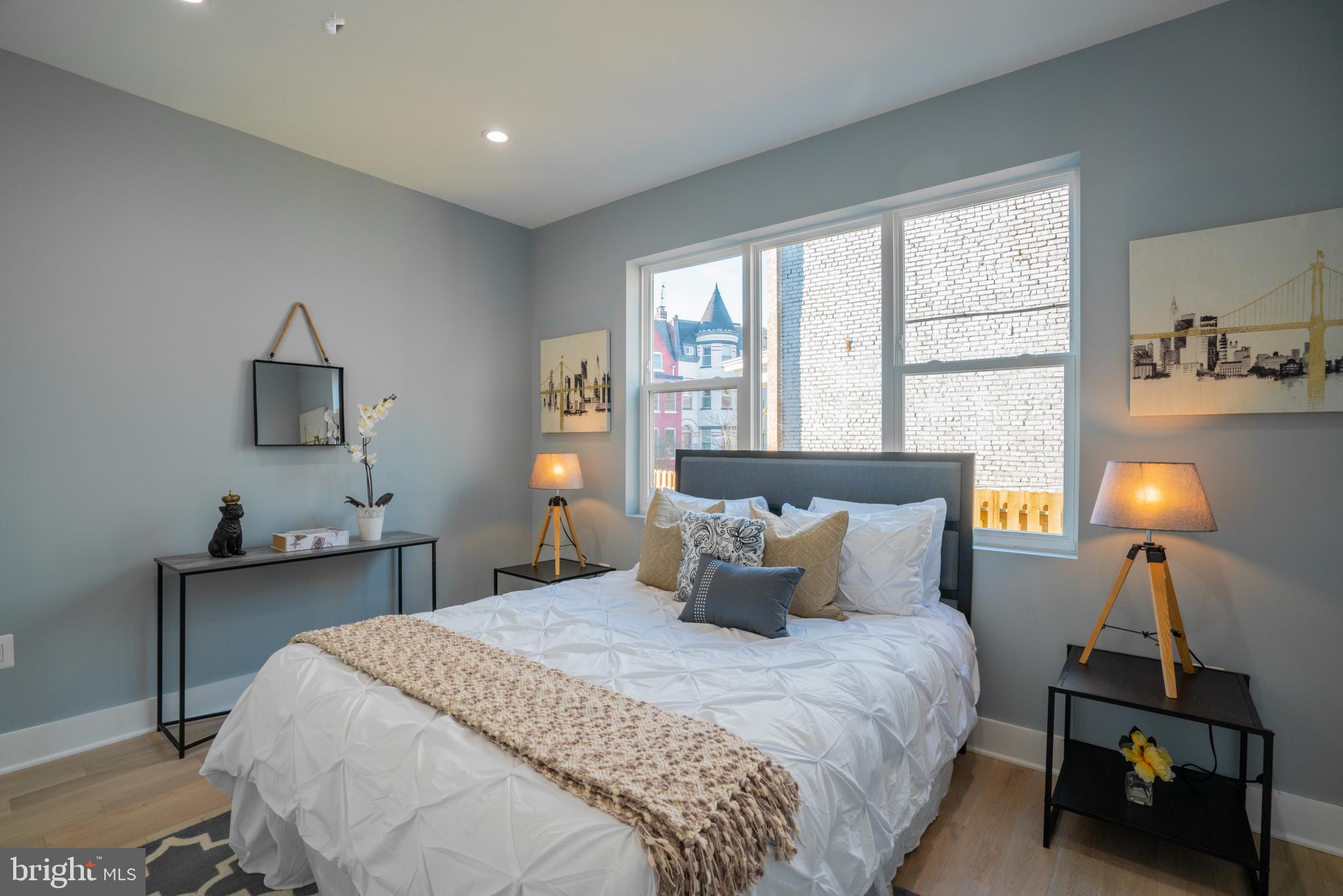 1225 Park Road Northwest, Unit 1 Washington, DC 20010 - Photo 15 of 38 a bedroom with a bed and a lamp