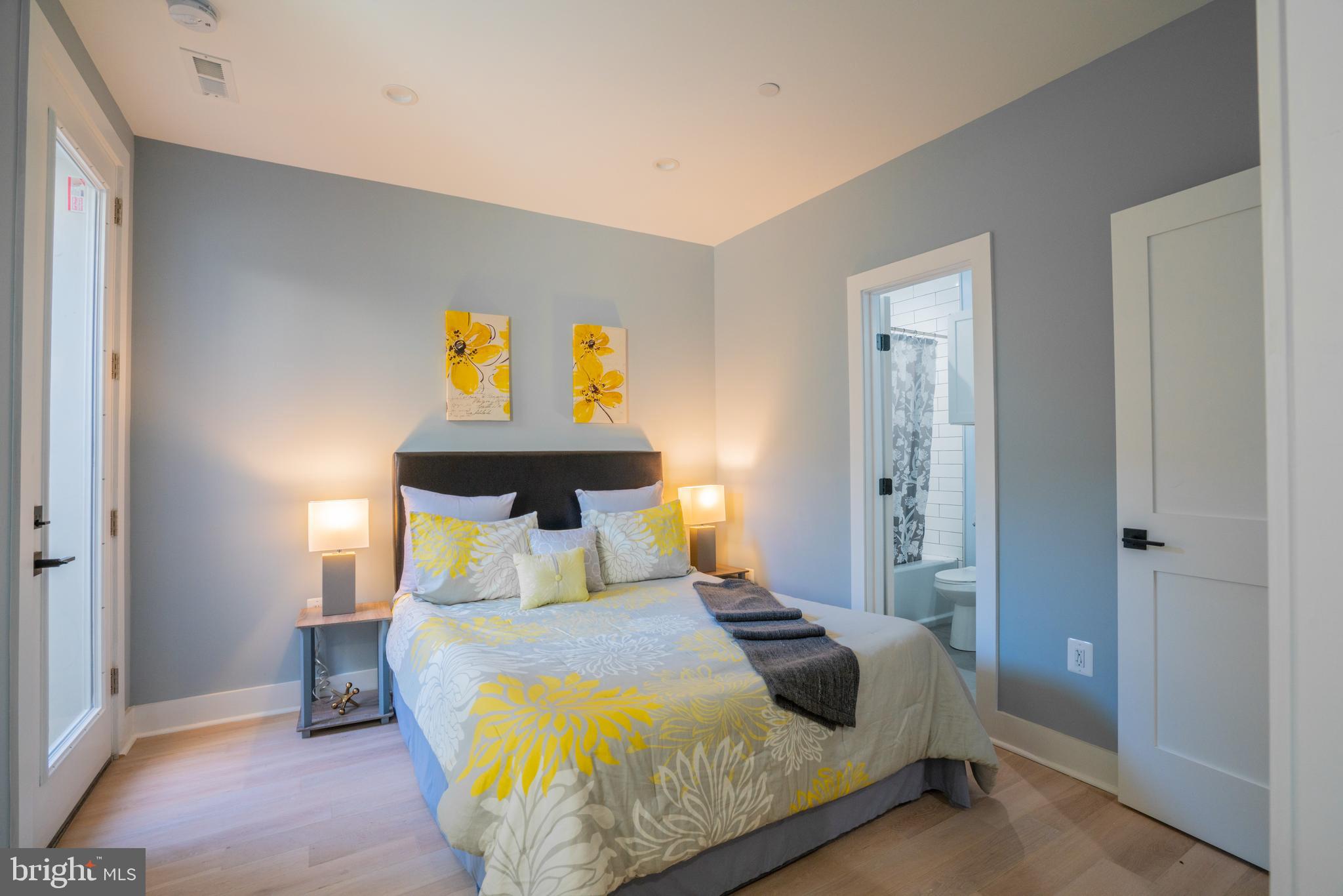 1225 Park Road Northwest, Unit 1 Washington, DC 20010 - Photo 19 of 38 a bedroom with a bed and painting on the wall