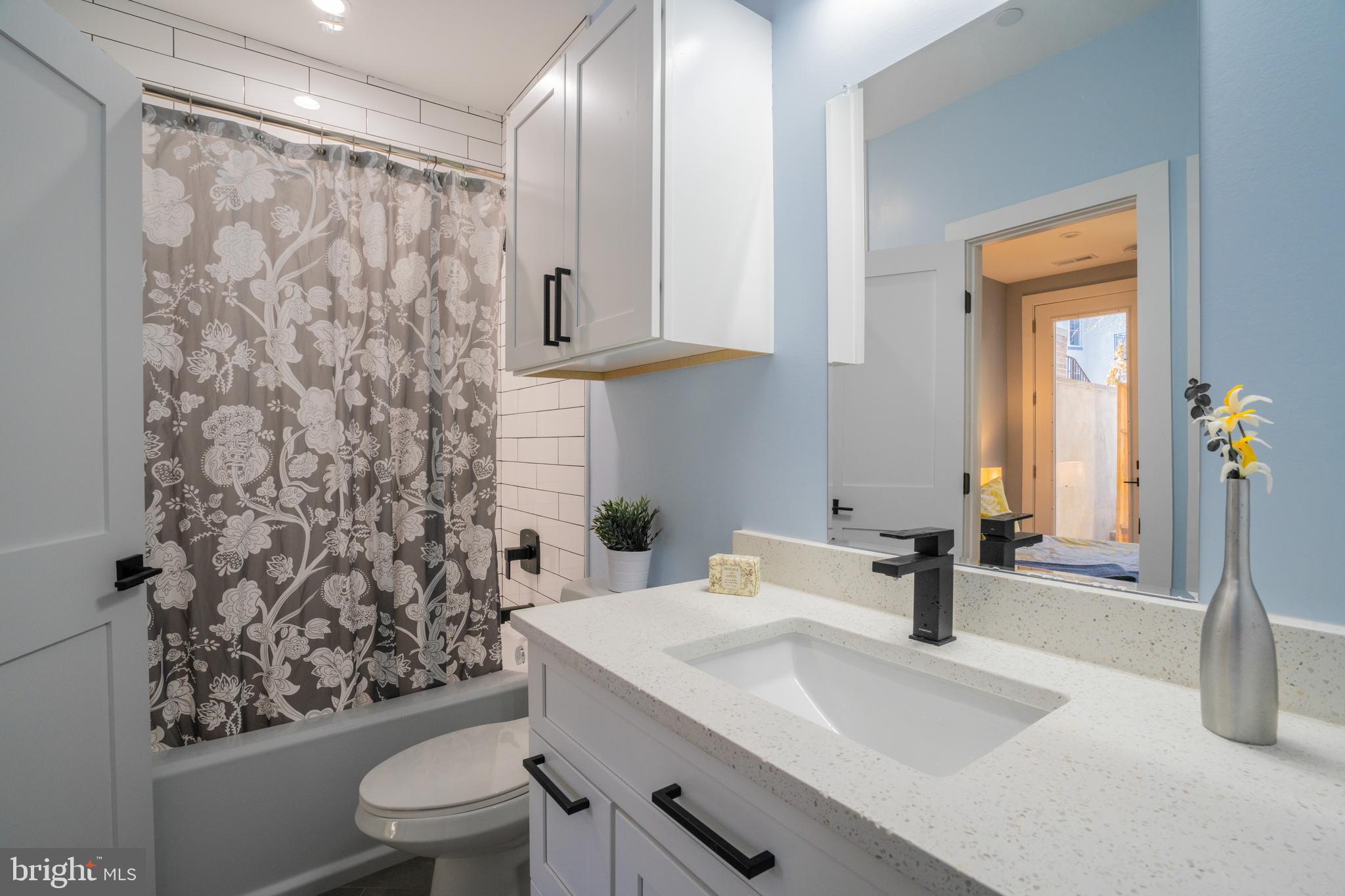 1225 Park Road Northwest, Unit 1 Washington, DC 20010 - Photo 22 of 38 a bathroom with a sink toilet and shower