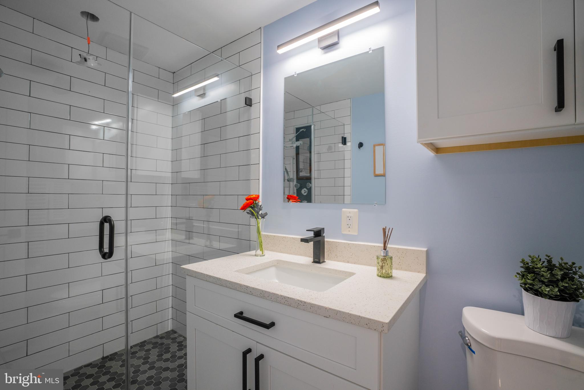 1225 Park Road Northwest, Unit 1 Washington, DC 20010 - Photo 25 of 38 a bathroom with a sink toilet and shower