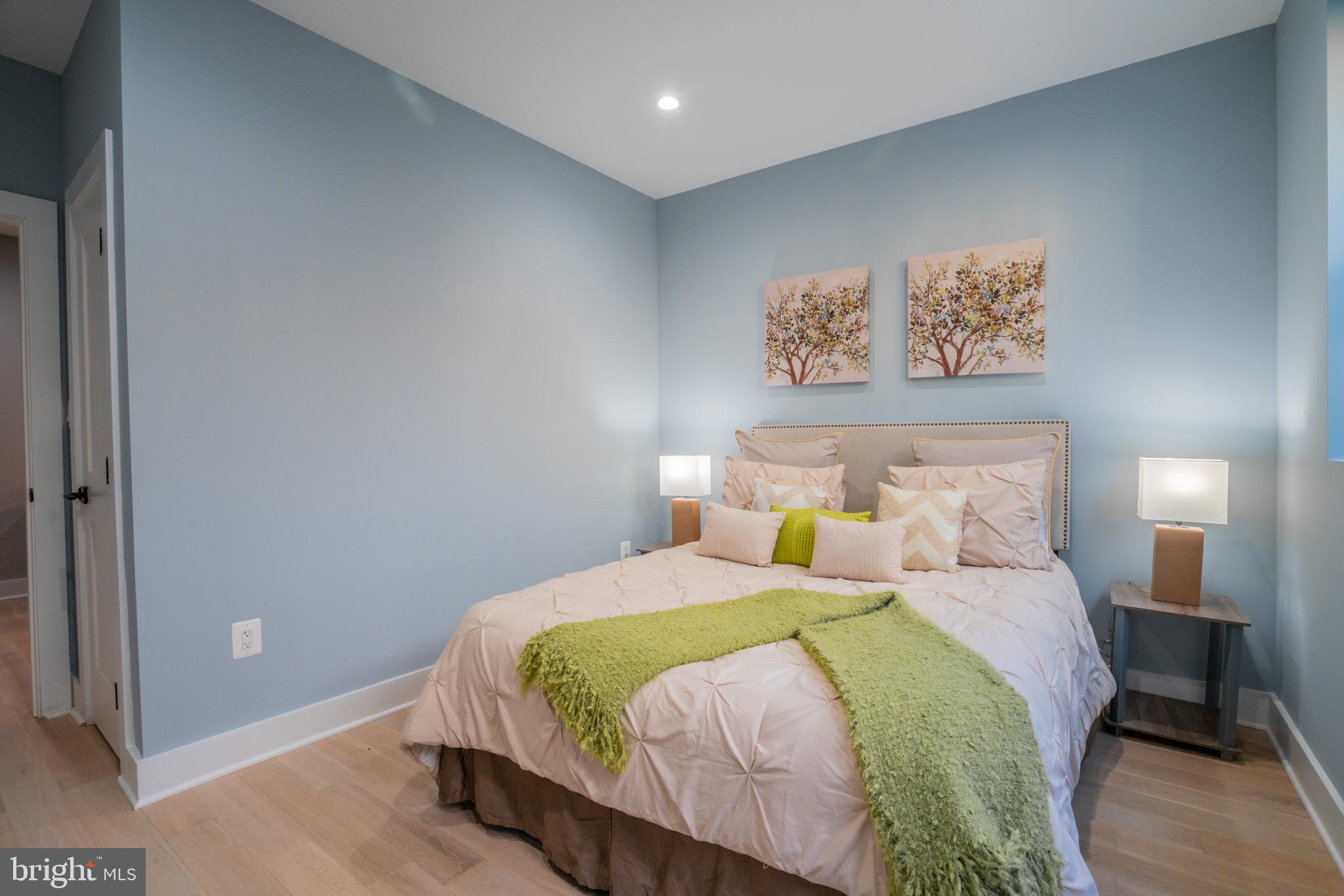 1225 Park Road Northwest, Unit 1 Washington, DC 20010 - Photo 27 of 38 a bedroom with a bed and painting on the wall
