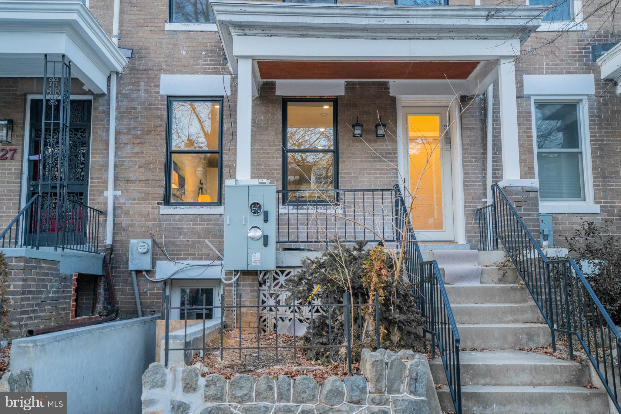 1225 Park Road Northwest, Unit 1 Washington, DC 20010 - Photo 3 of 38 a front view of a house with a garden