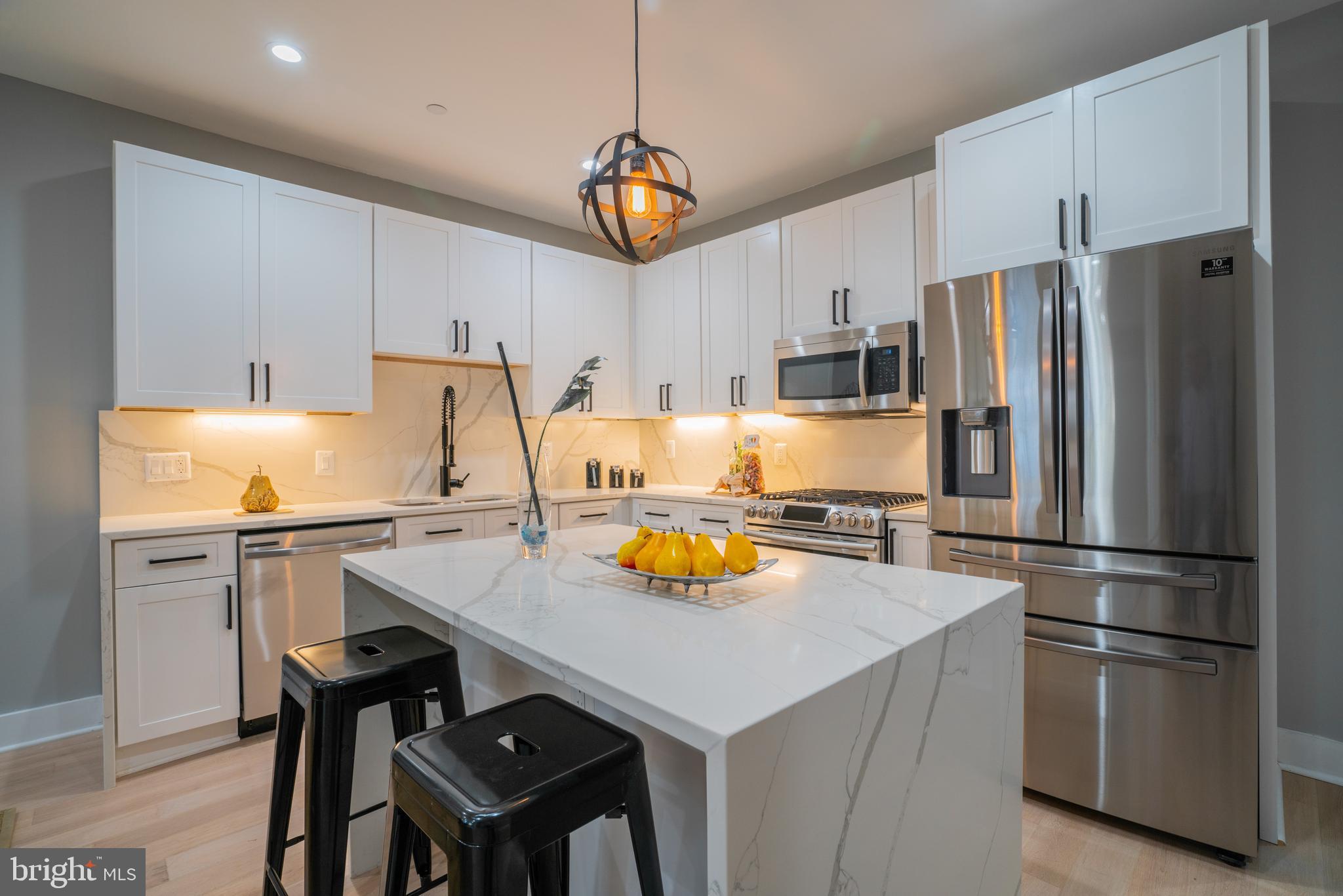 1225 Park Road Northwest, Unit 1 Washington, DC 20010 - Photo 4 of 38 a kitchen with stainless steel appliances a sink and a refrigerator