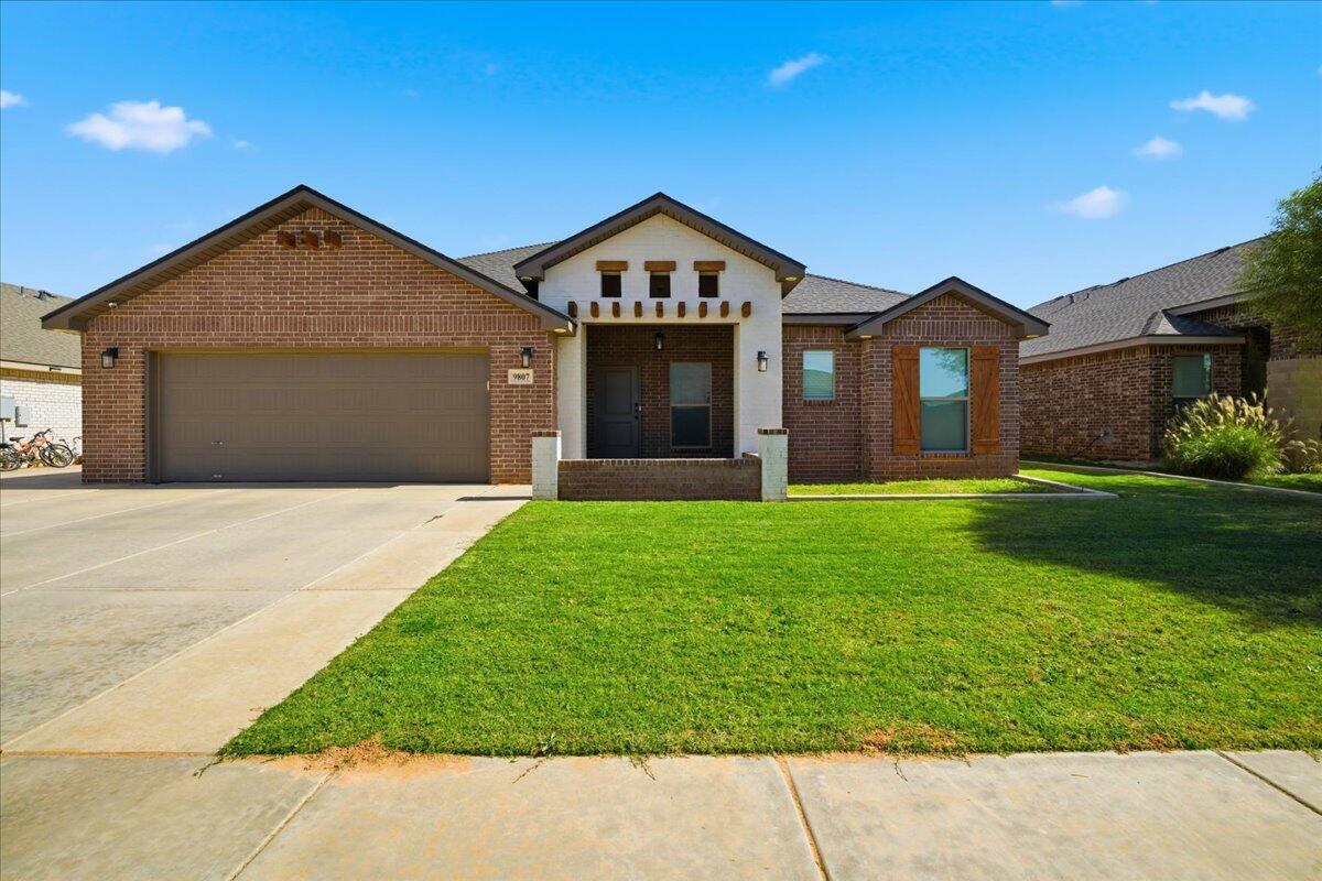 a front view of a house with a yard and garage