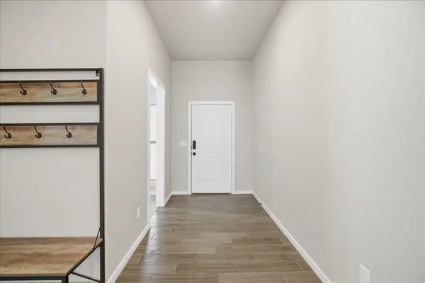 a view of a hallway with wooden floor