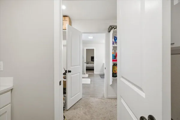 a view of a hallway with wooden floor and staircase