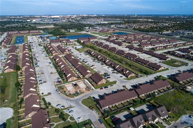 an aerial view of residential houses with outdoor space