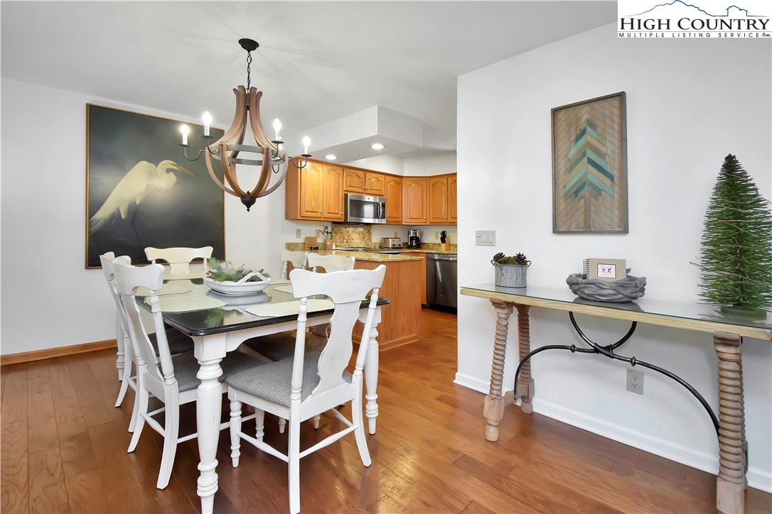 140 Manor View Lane, Unit CASCADES 2 Blowing Rock, NC 28605 - Photo 12 of 25 a view of a dining room with furniture and wooden floor