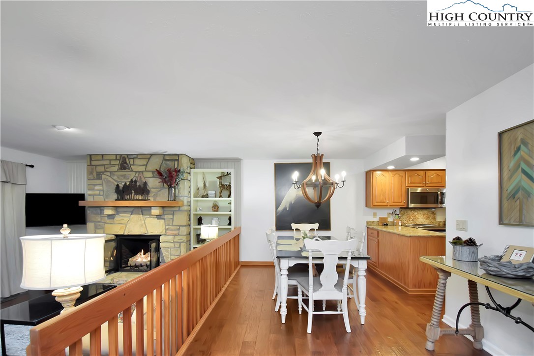 140 Manor View Lane, Unit CASCADES 2 Blowing Rock, NC 28605 - Photo 13 of 25 a view of a dining room with furniture window and wooden floor