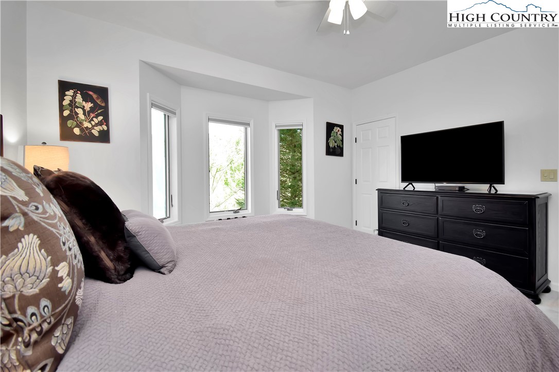 140 Manor View Lane, Unit CASCADES 2 Blowing Rock, NC 28605 - Photo 17 of 25 a bedroom with a bed and a flat screen tv