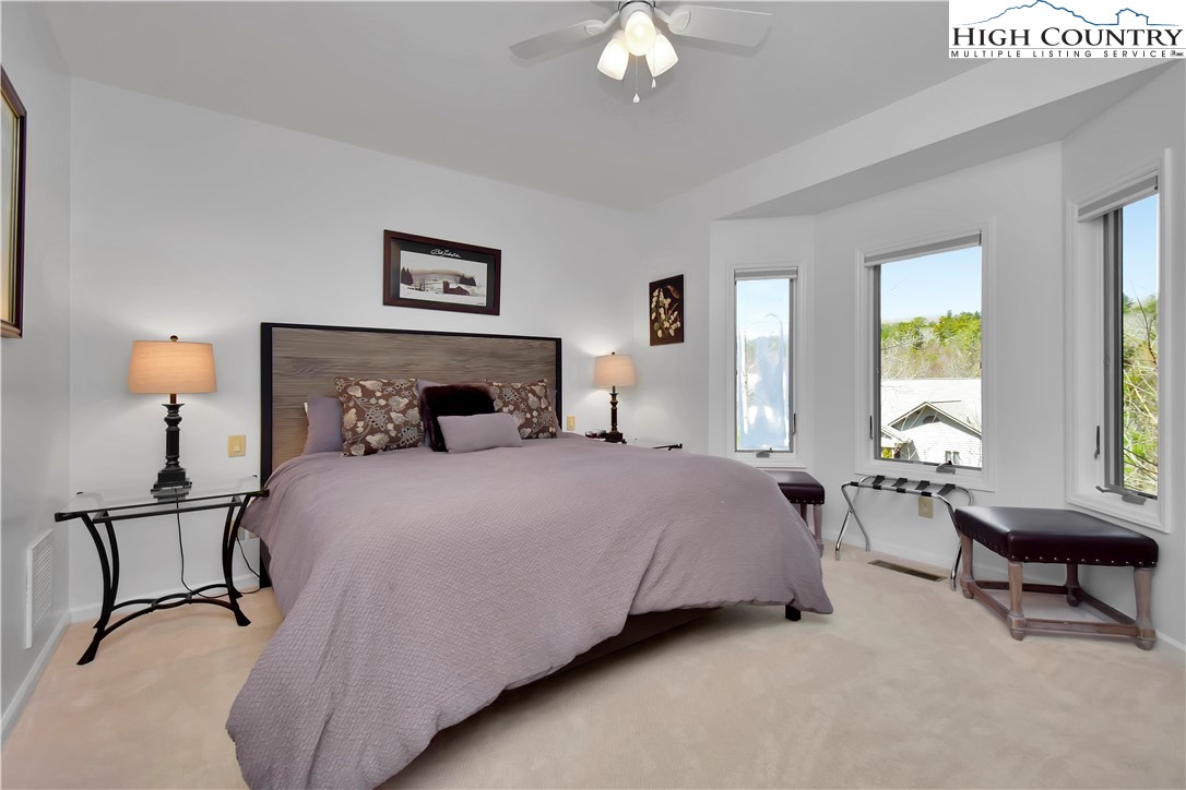 140 Manor View Lane, Unit CASCADES 2 Blowing Rock, NC 28605 - Photo 19 of 25 a bedroom with a bed a couch and a window